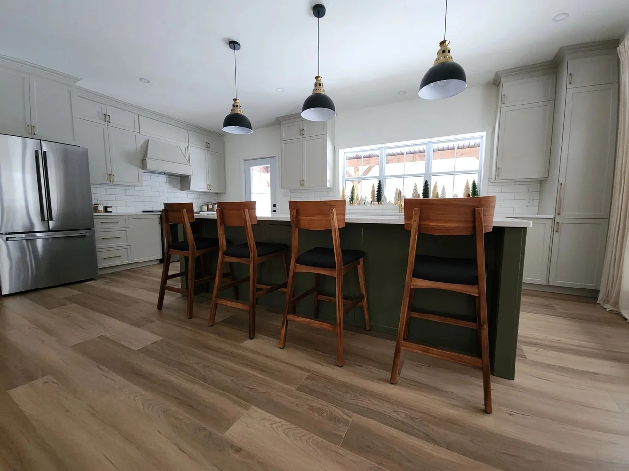 Kitchen island with wood seating and pendant lights