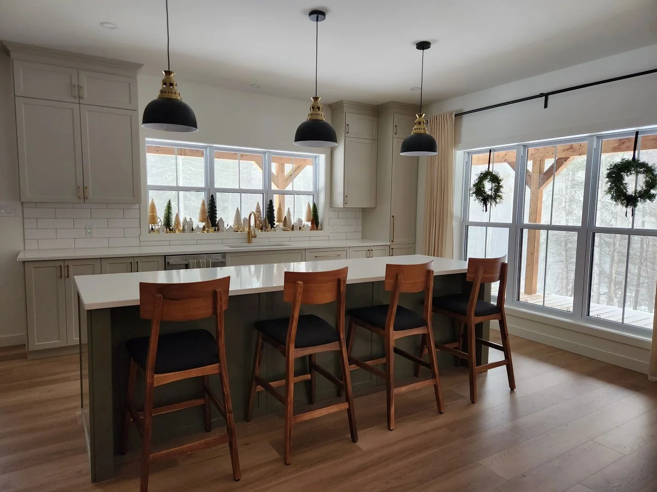 White cabinetry surrounding a wood-accented island
