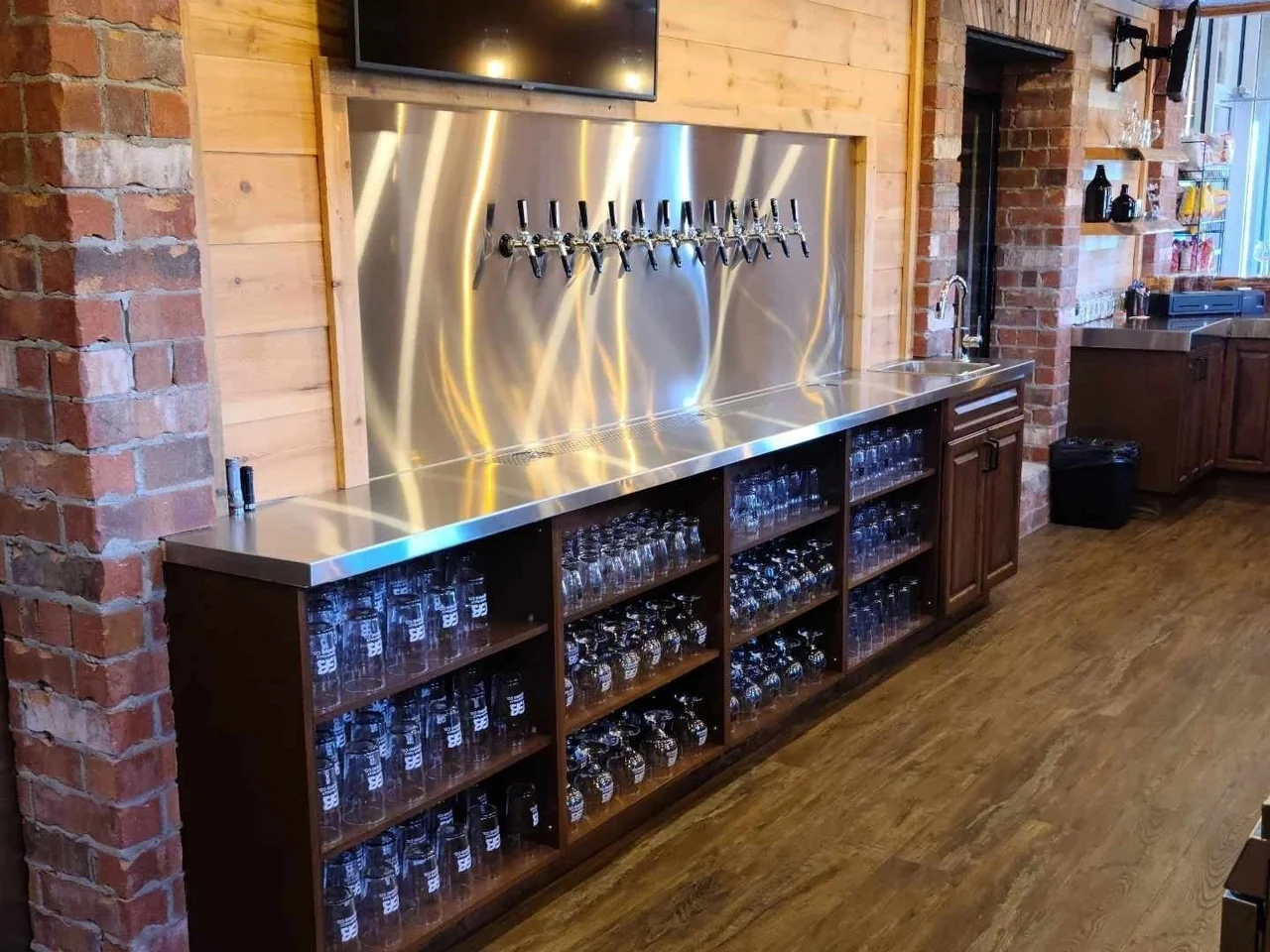 Bar cabinetry with glass storage and beer taps